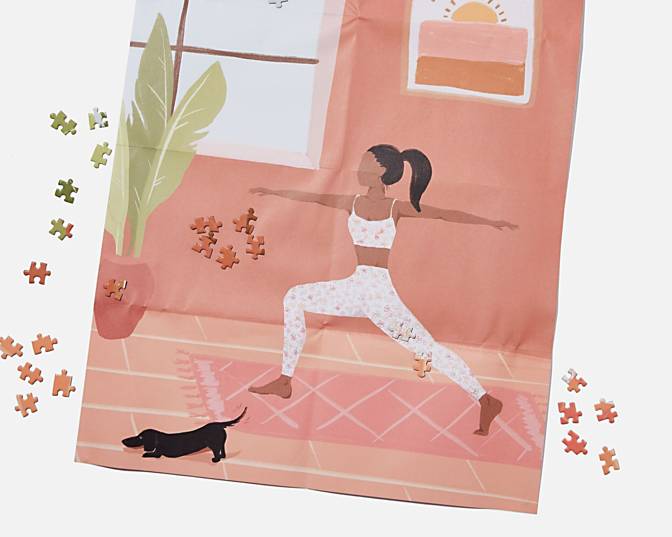 The cute, pink poster matching the jigsaw image depicts a woman doing yoga beside her cat
