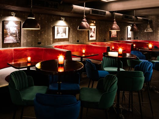 Red lamplit booths at Jolene's Bar in Sydney