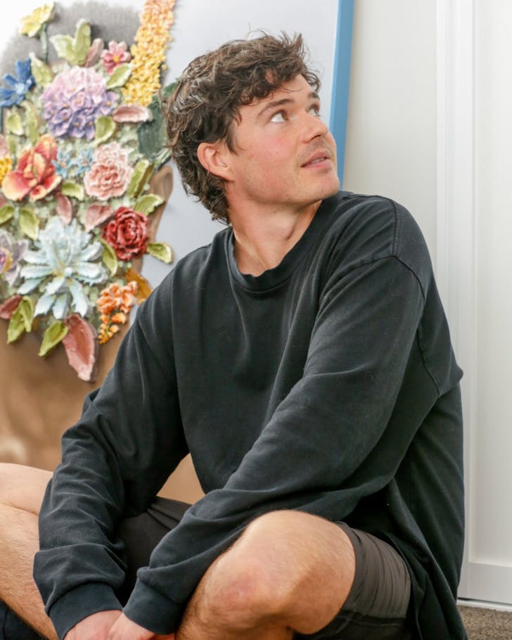 Josh Davison sits before one of his beautiful works of art.
