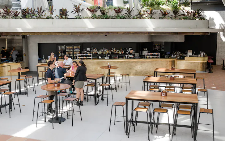 high tables in front of a brass bar