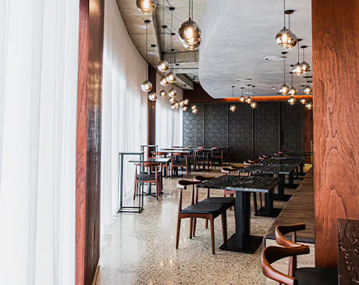 interior of a sophisticated restaurant, with black and dark wooden furtniture