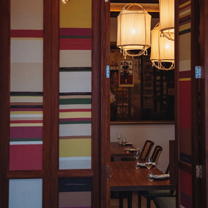 a private dining room with hanging lanterns