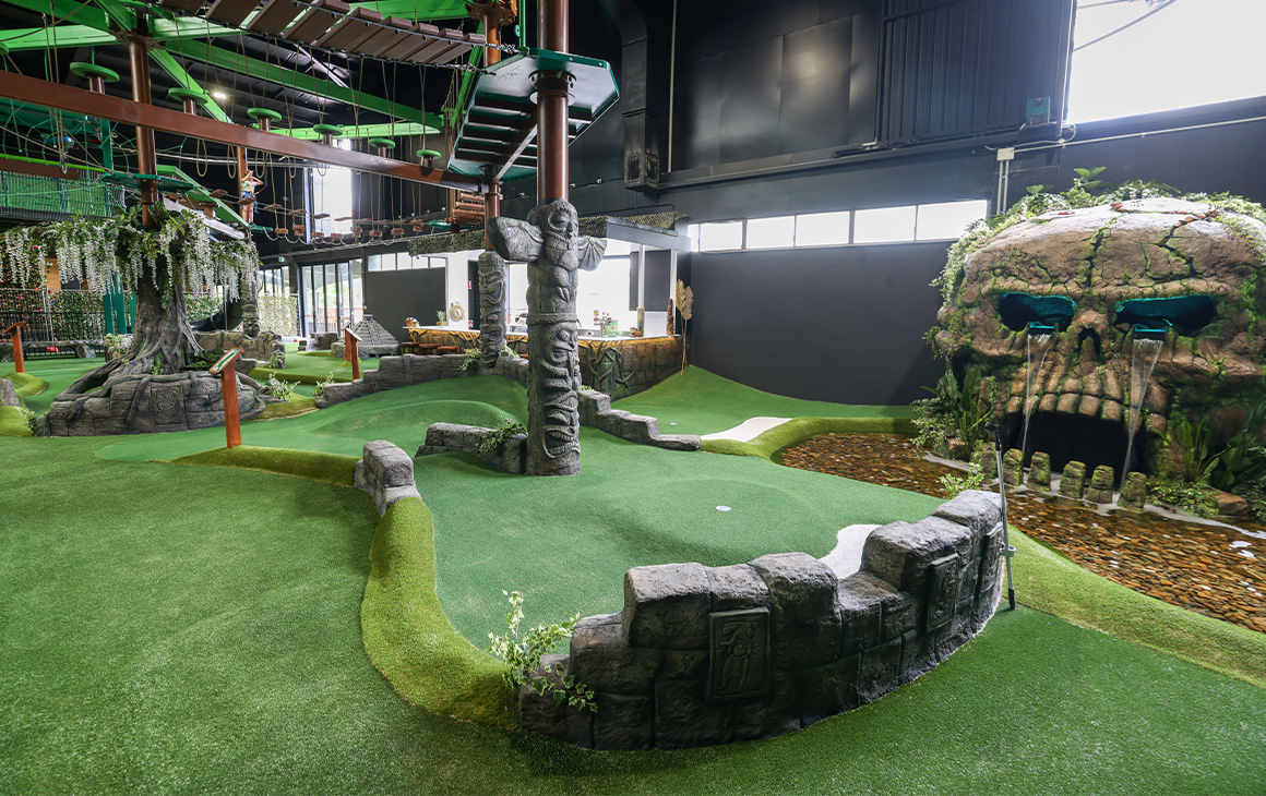 a mini golf course with a large skull 