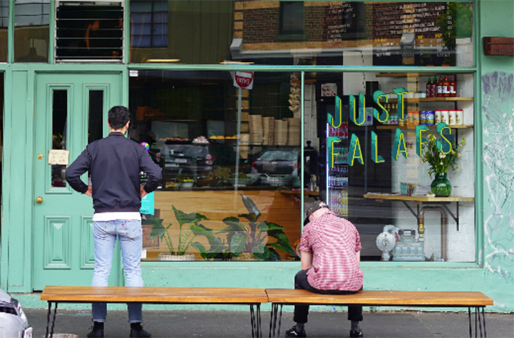 Two people out standing out front of one of the best vegetarian restaurants in Melbourne