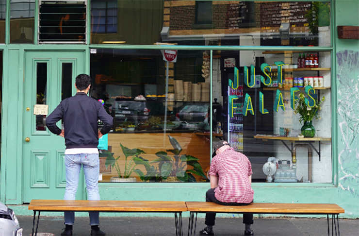 A green shop front with a logo that reads 