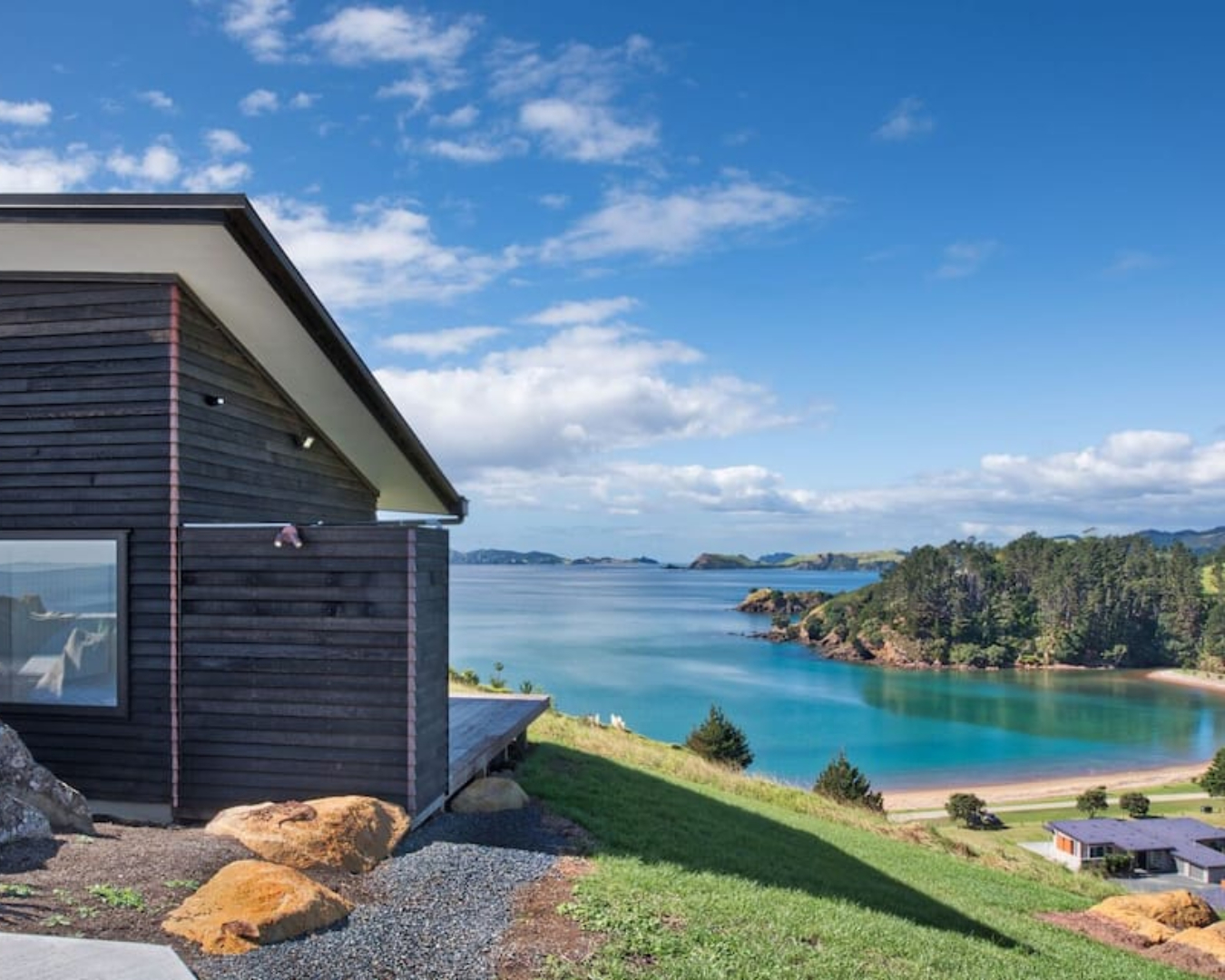 The azure ocean sparkles right across from this beachfront stay in Northland