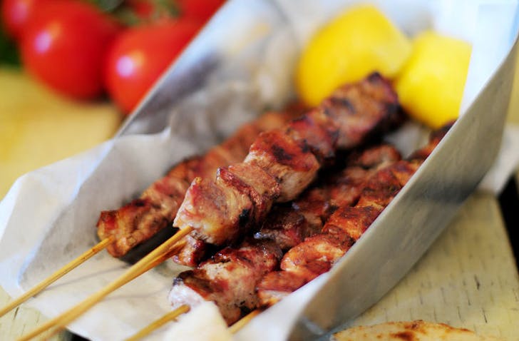 A tray with chargrilled skewers of pork, a best cheap restaurant Melbourne. 
