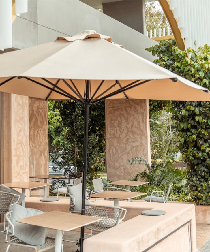 tables under umbrellas outside Cups on Wellington, a kangaroo point cafe