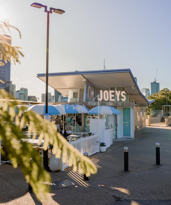 the front of joeys, with blue striped umbrellas