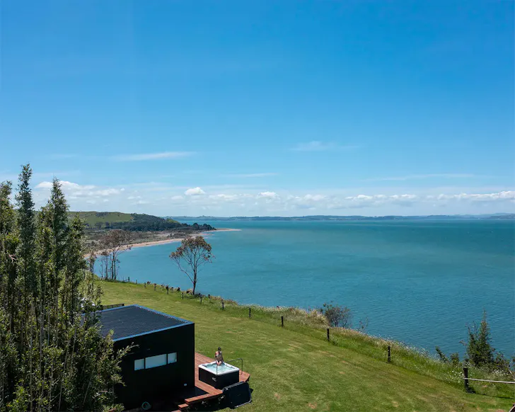 An aerial view of Kapia Lodge by the sea, one of the best romantic stays near Auckland
