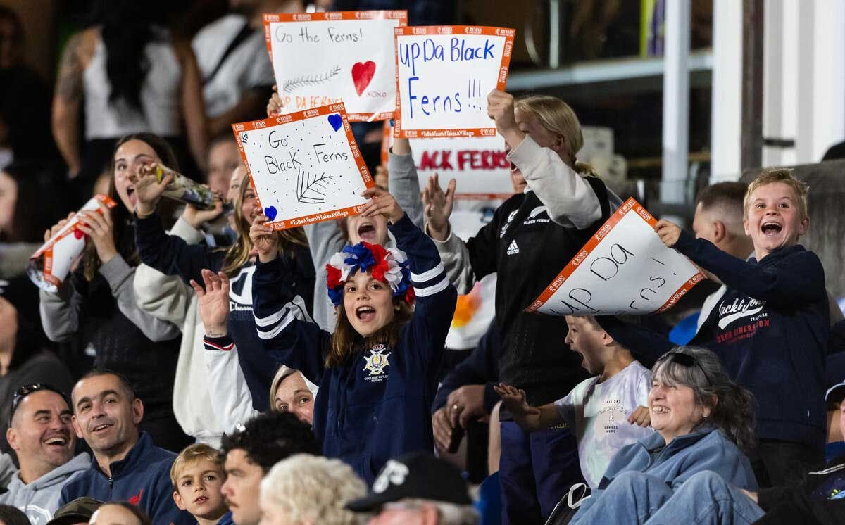 Kids celebrating in the crowd of a Black Ferns match