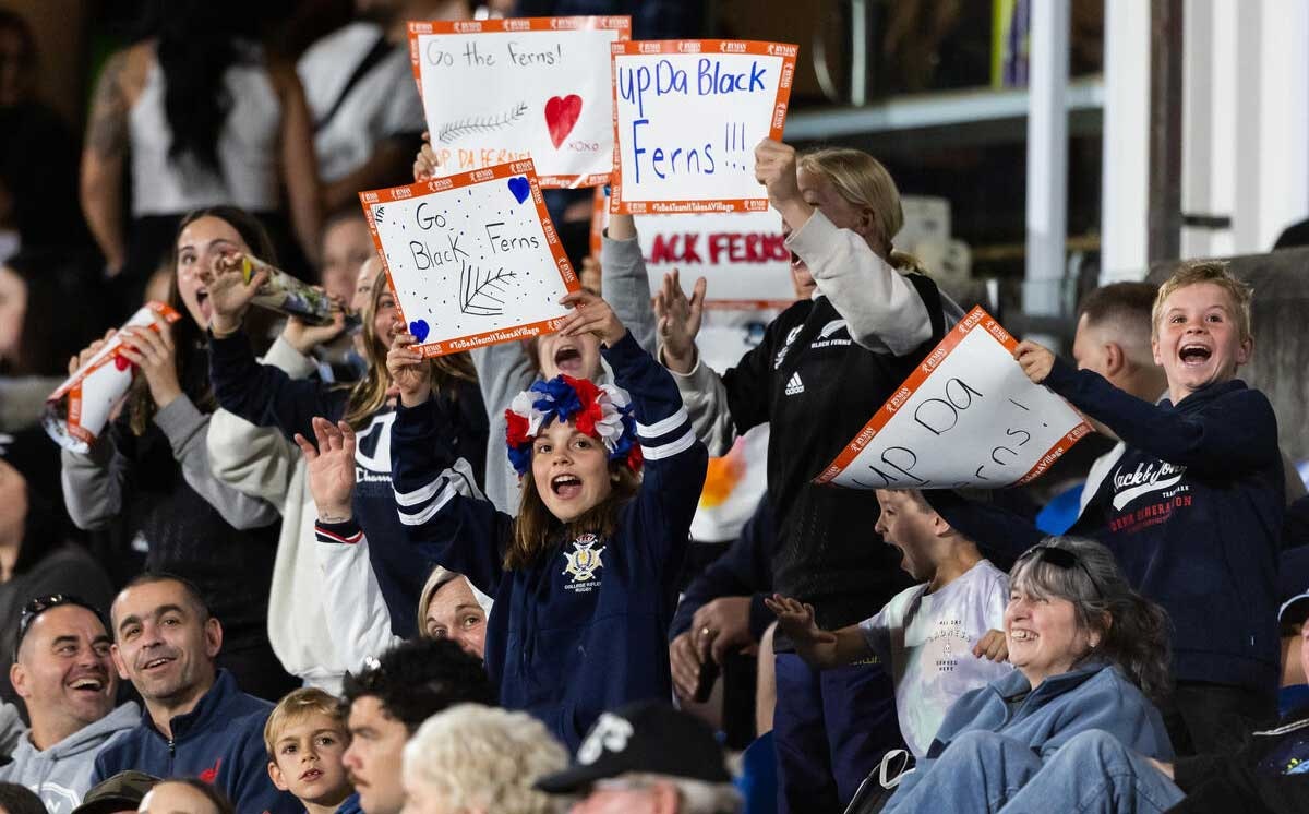 Kids celebrating in the crowd of a Black Ferns match
