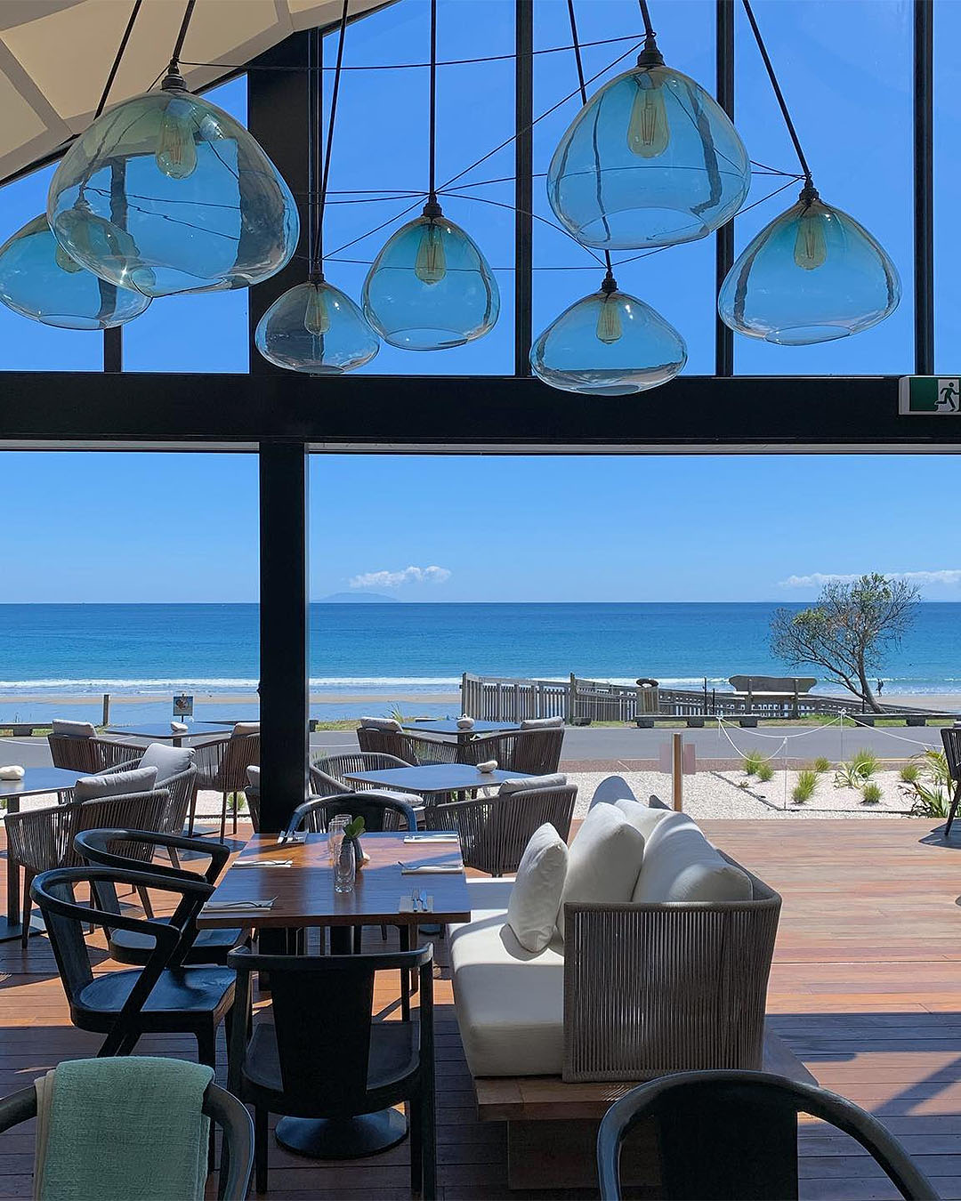 The dining room at Ki Māha on a stunning sunny day on Waiheke island.