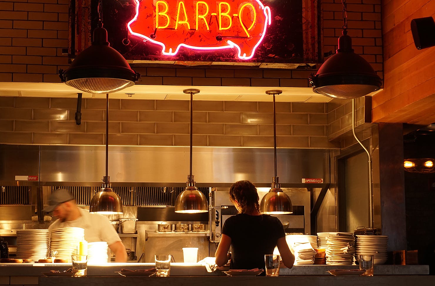 A server and chef attend to orders.