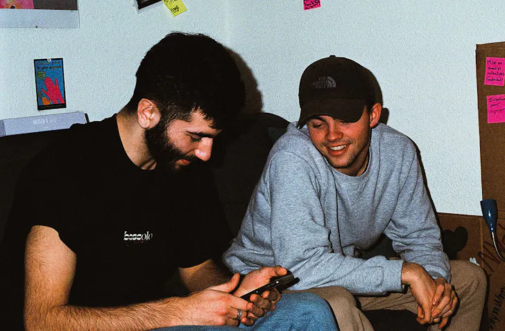 Friends look at a phone.