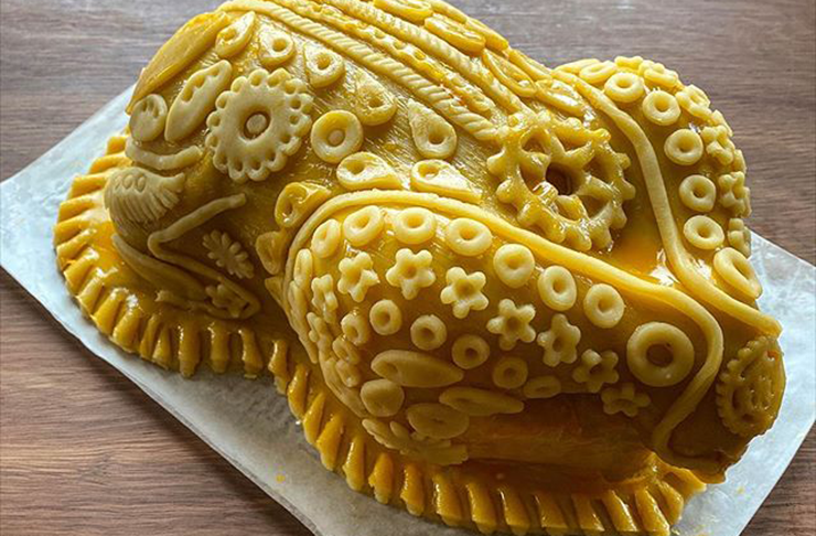 A chicken encrusted and decorated in pastry. 