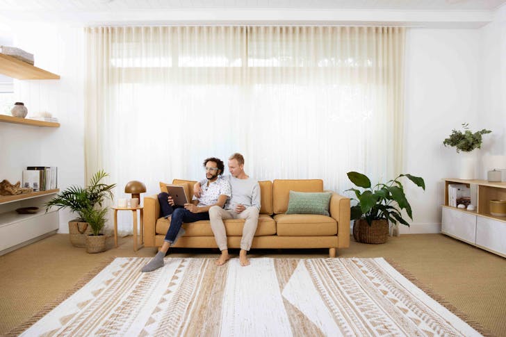 two men sitting on a couch