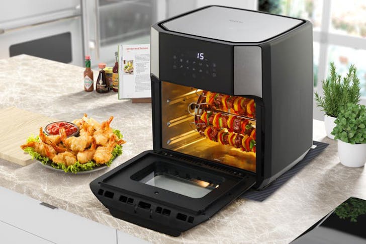 One of the best air fryers under $200 on a kitchen bench next to food.