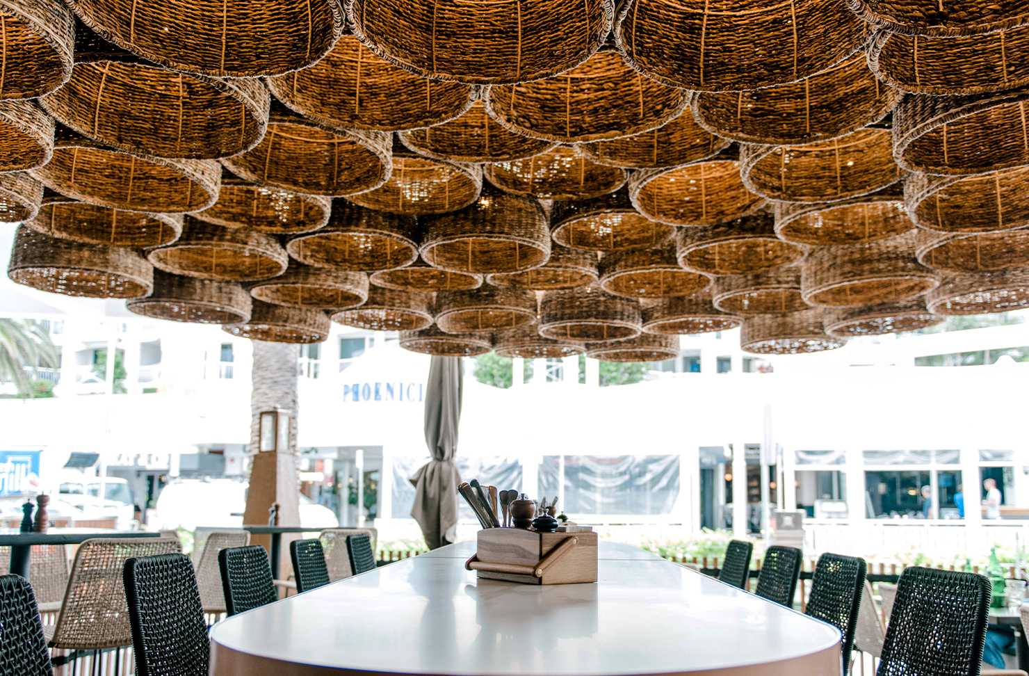 a dining table with overhead bamboo feature