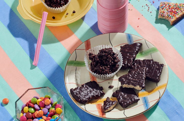 Koko Black's chocolate crackles on a plate with Smarties and Fairy Bread surrounding it.