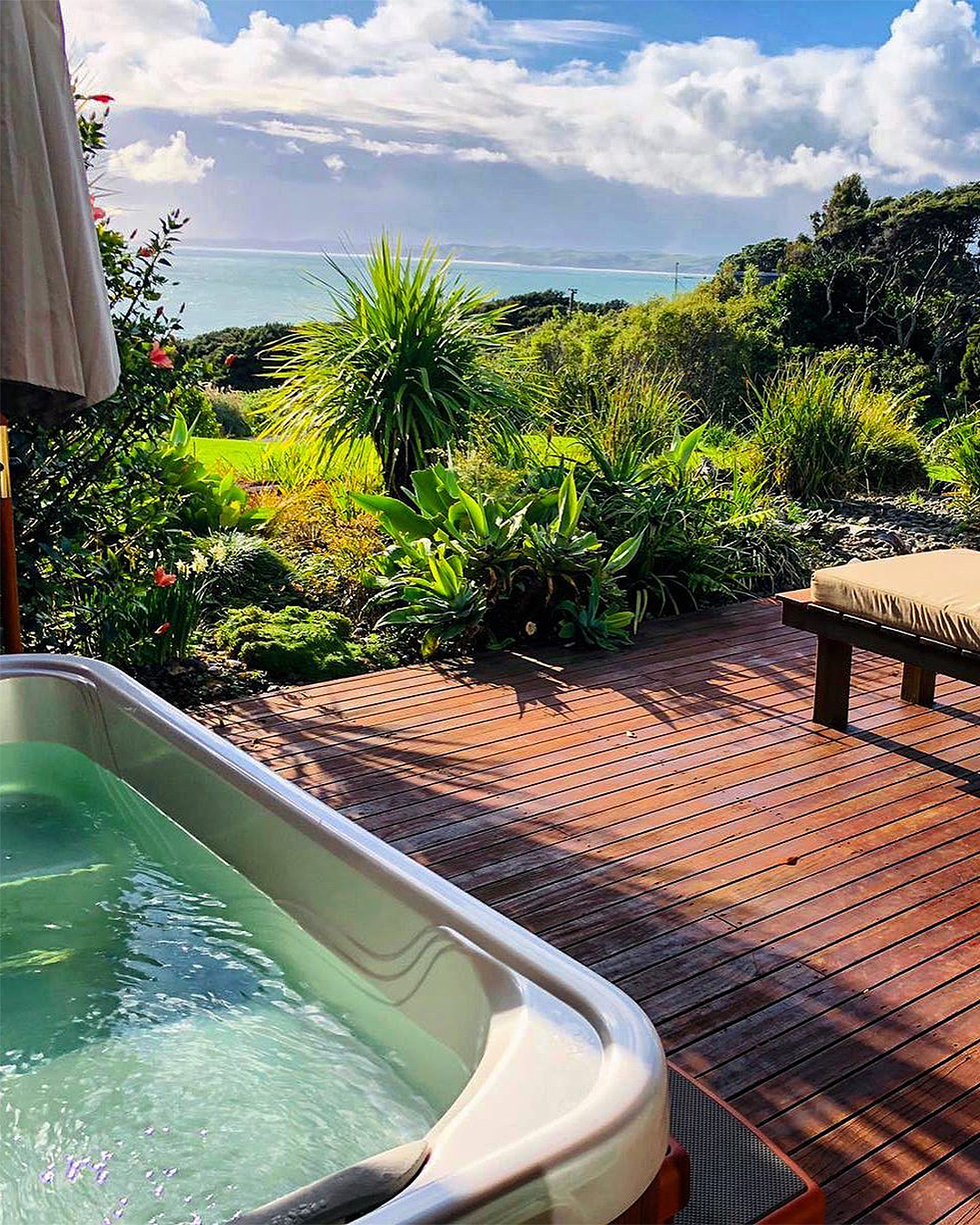 An outdoor hot tub looks out onto a lovely view.