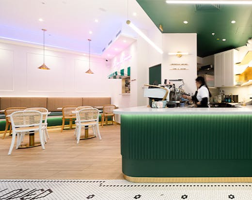 interior of a pretty cafe with a dark green counter