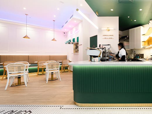 interior of a pretty cafe with a dark green counter