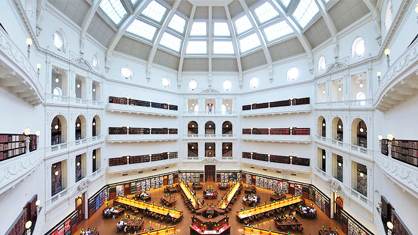 The inside of the State Library, one of the best things to do in Melbourne with white domed ceiling.