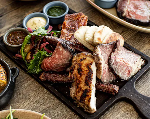 a tray of different meats and sauces