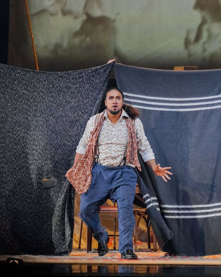 An actor in La bohÃ¨me rushes onto stage.