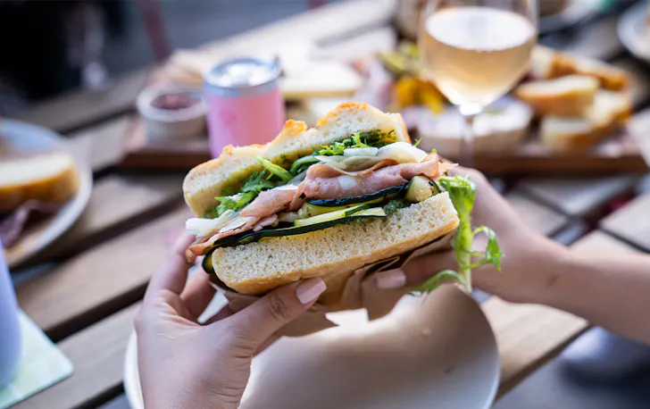 hands holding a focaccia sandwich