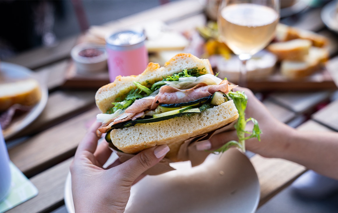 hands holding a focaccia sandwich