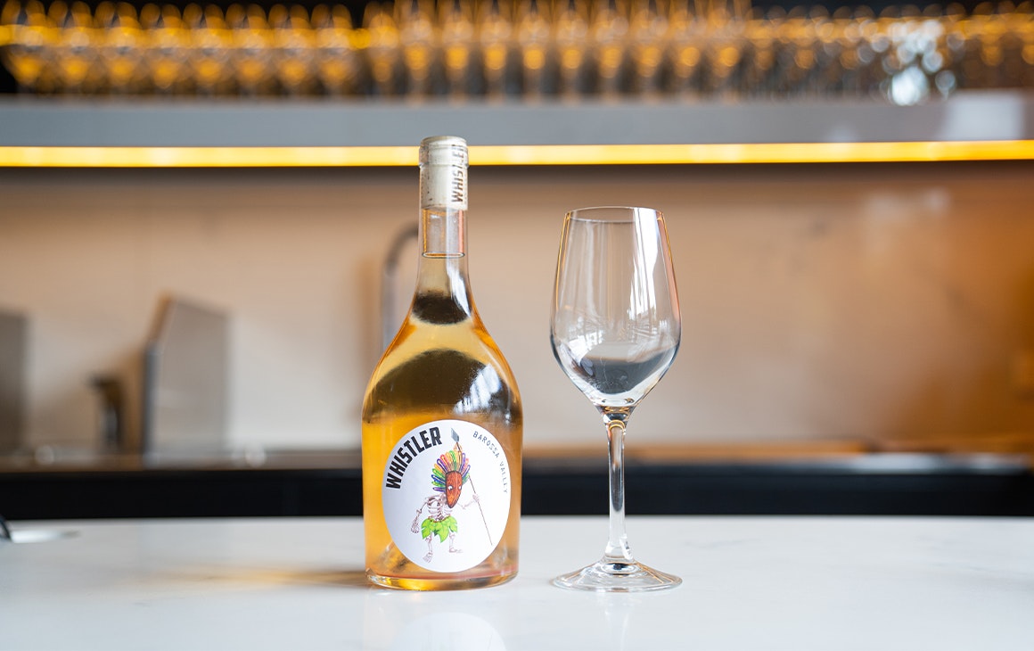 a bottle of pet nat wine on a bar