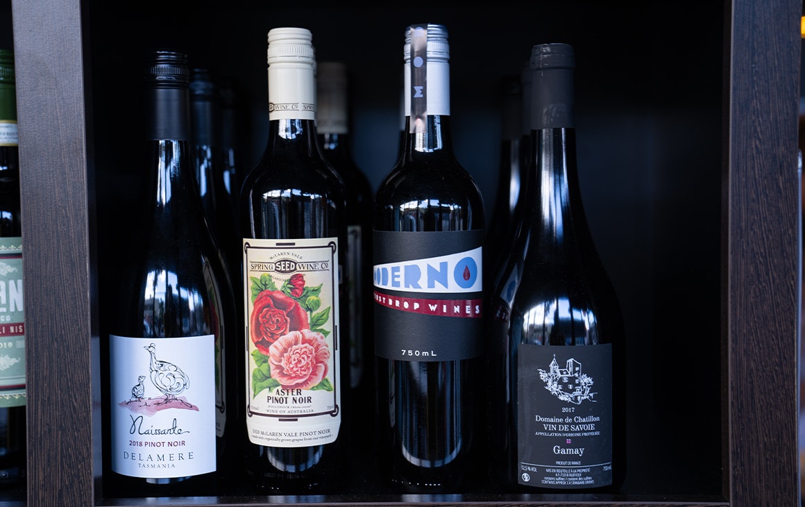 four bottles of wine on a shelf