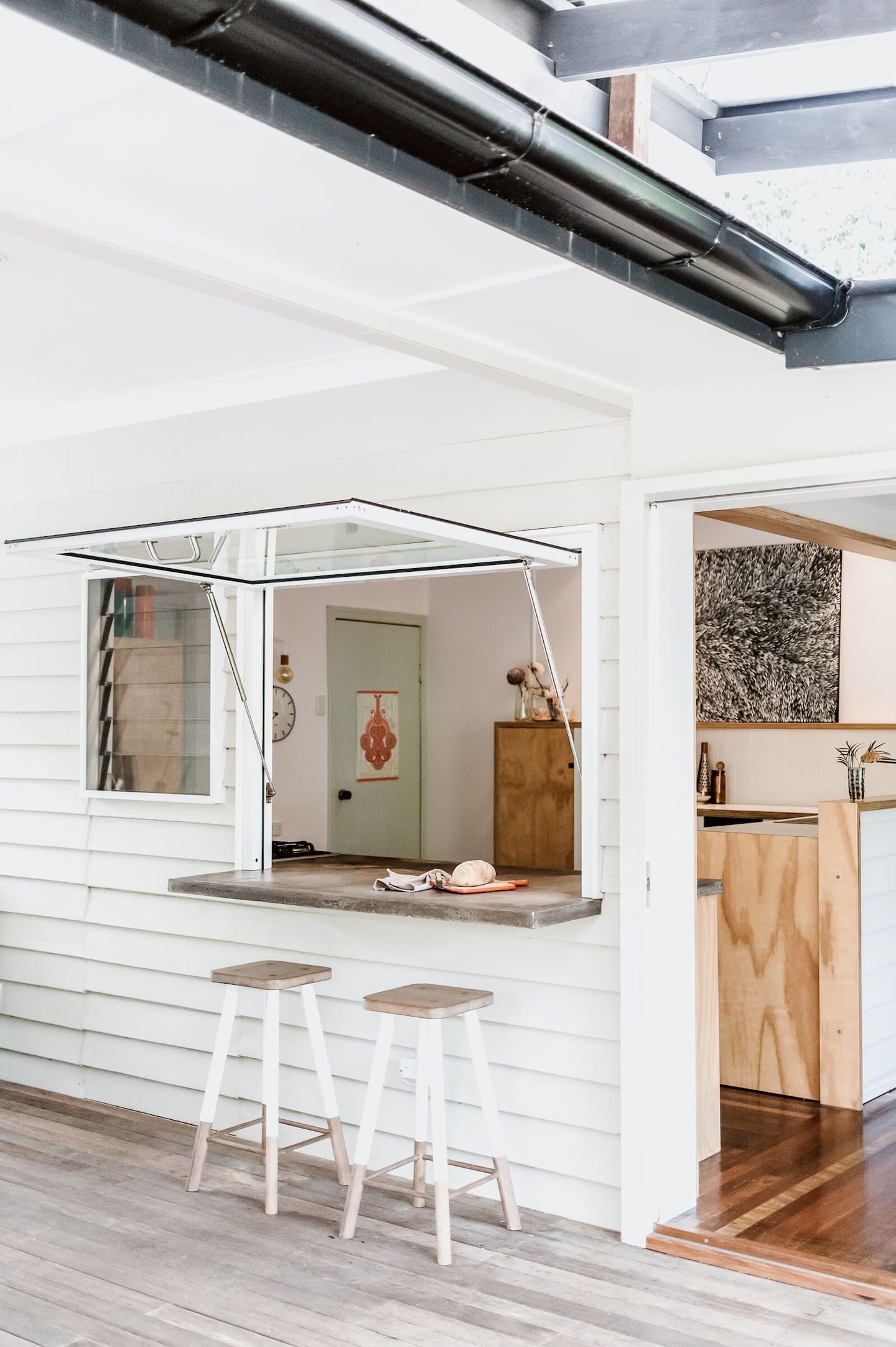 a kitchen with a bar window 