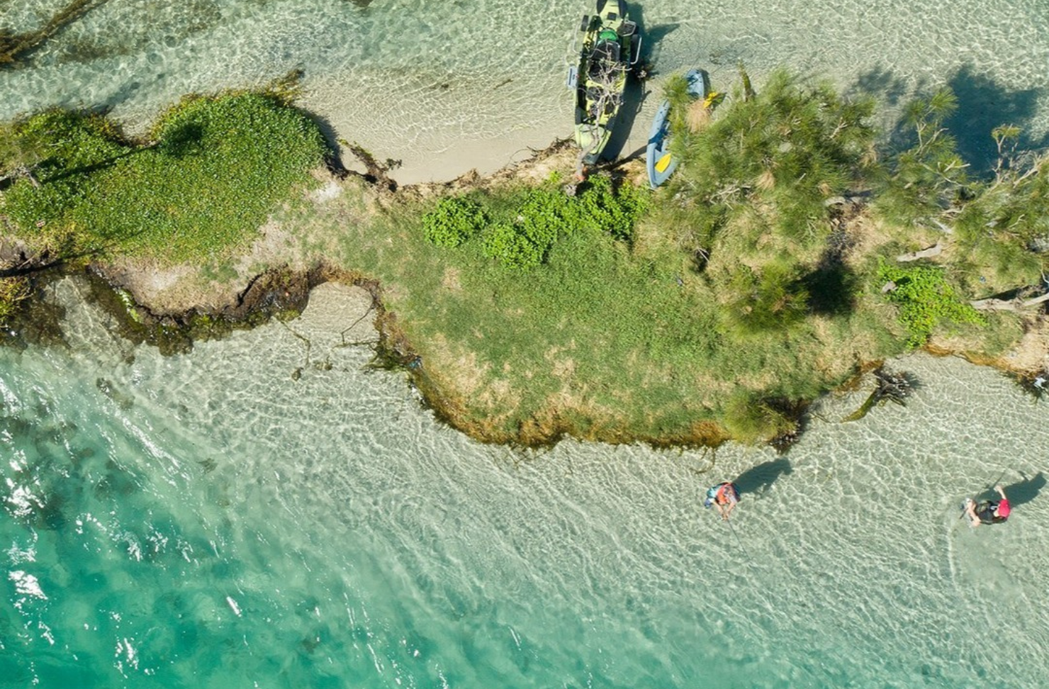 A bird's eye view of Lake Macquarie, where two men are fishing in shallow waters