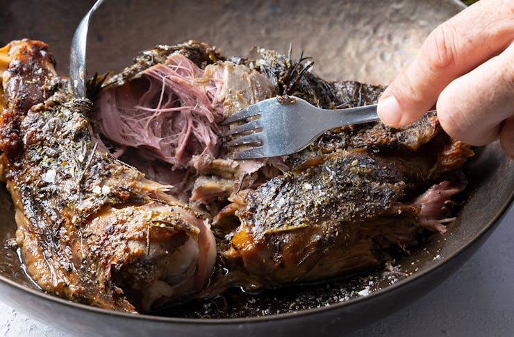 lamb shoulder being pulled apart by two forks
