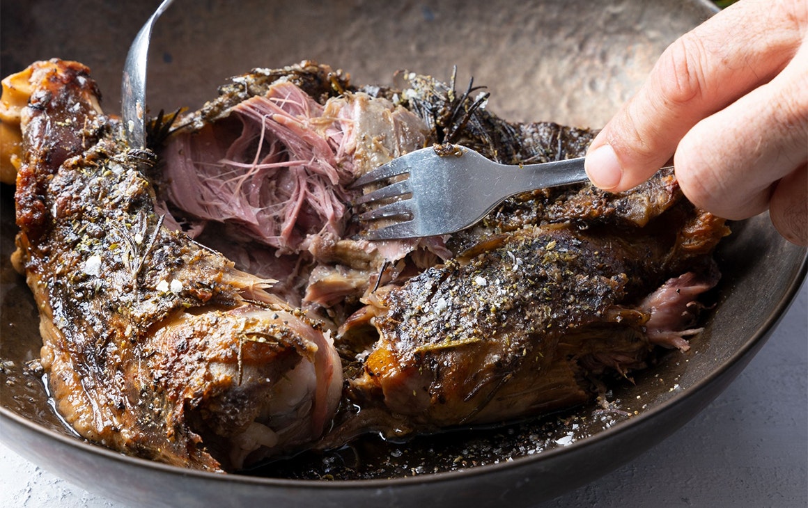 lamb shoulder being pulled apart by two forks