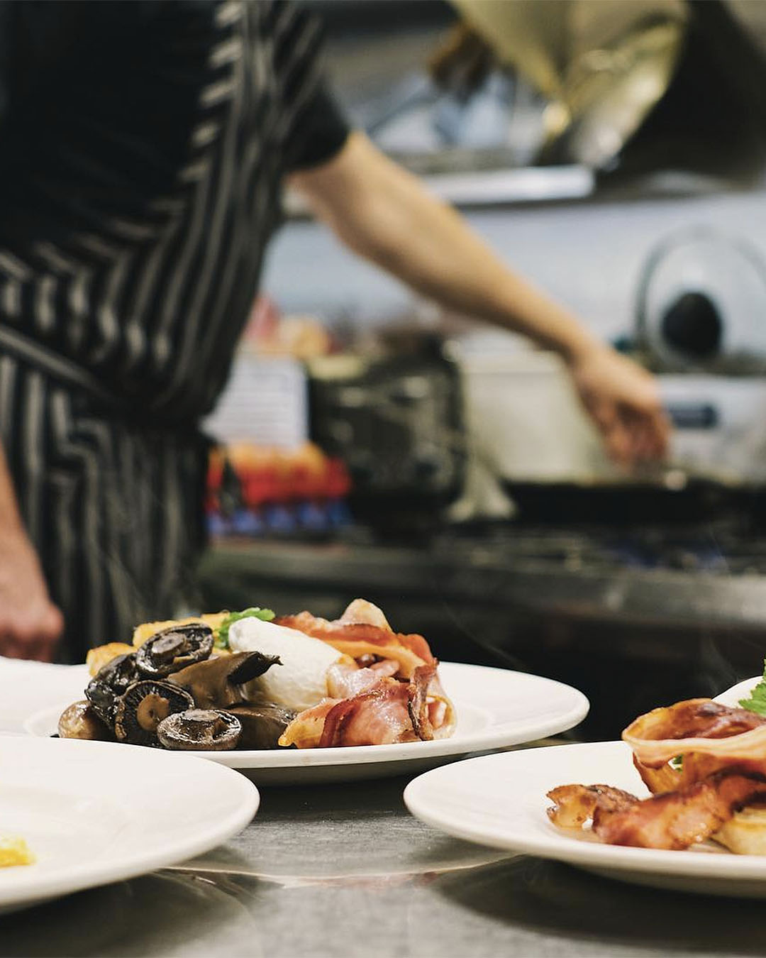 The chef hard at work preparing dishes in the kitchen at Lambretta's