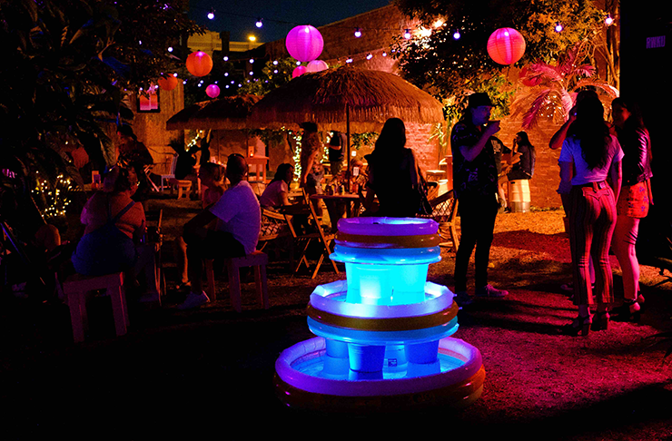 A neon lit 880s style garden bar.