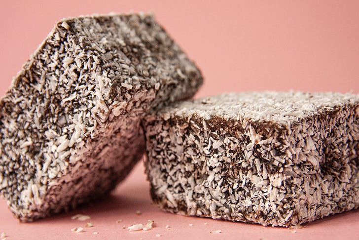 two lamingtons against a pink background