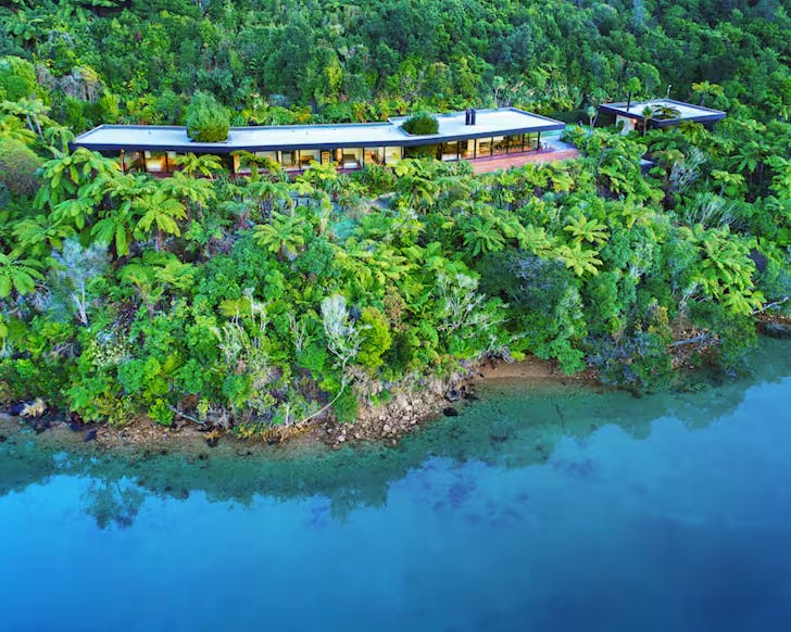 An expansive, modern property amongst the cliff-side native bush and before the ultra-blue waters of the Sounds.