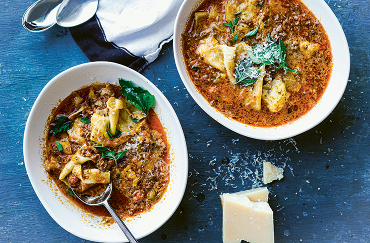 Two bowls of thick, red lasagne soup.