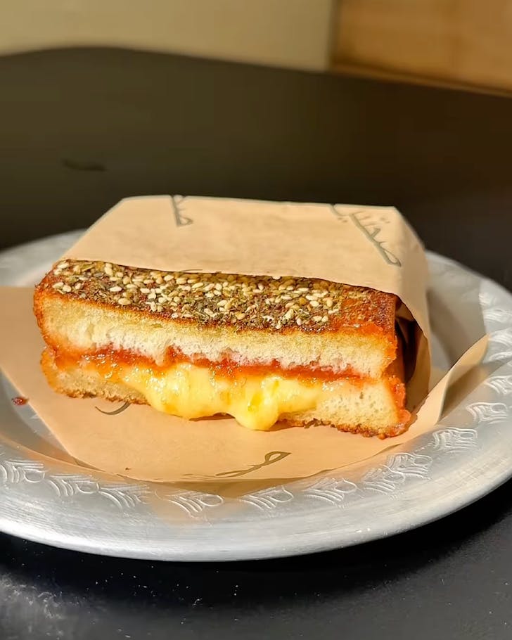 A delicious-looking Lebanese Grocer toastie on a plate.