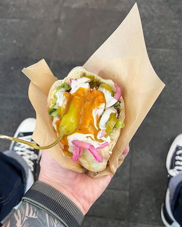 Someone holding a pita from Yalla Bala in Leederville
