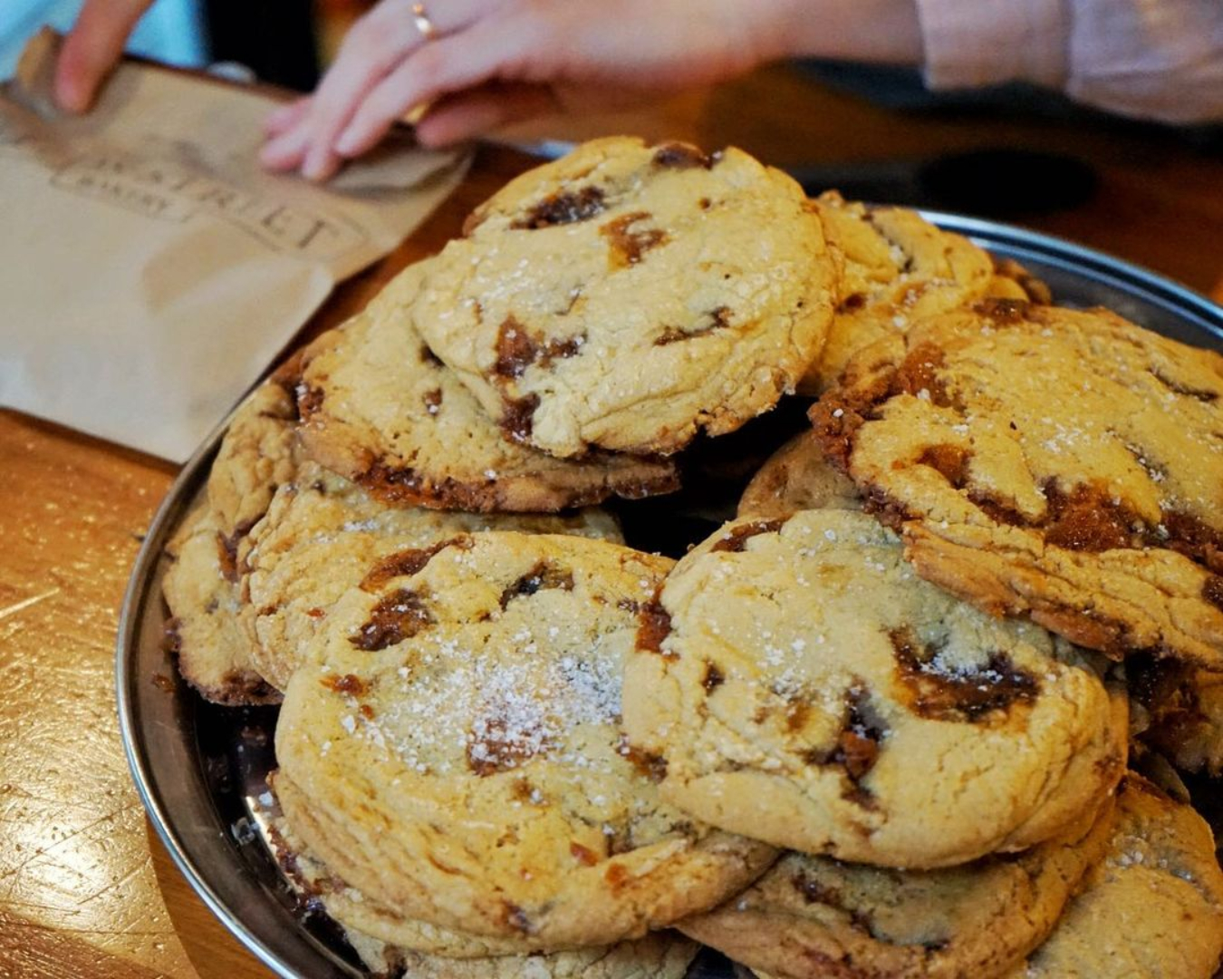 A plate of the beloved Salted Caramel Cookies at Leeds Street Bakery