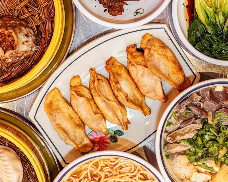 Above view of fried crispy dumplings served in a bamboo steamer.