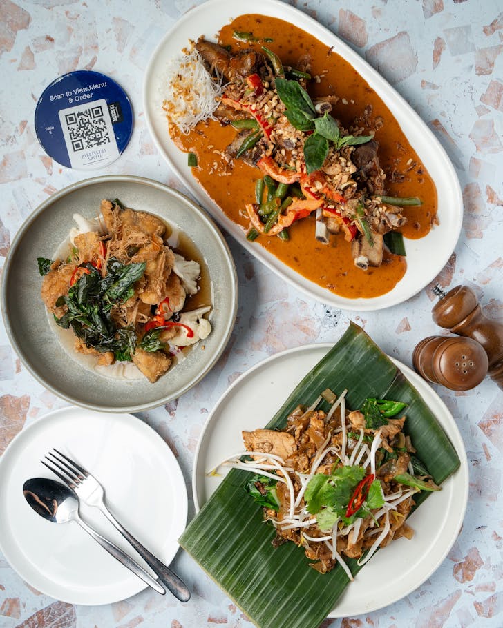 pad thai and a stir fy on a table at Lek's Thai restaurant in Brisbane