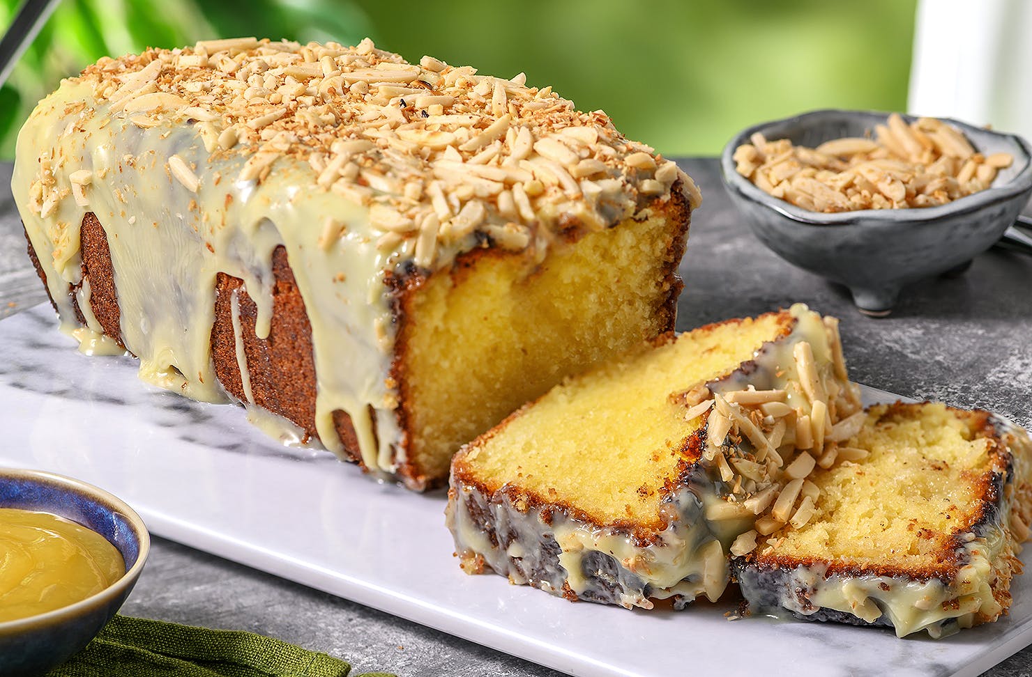 A lemon drizzle cake on a plate looks delicious.