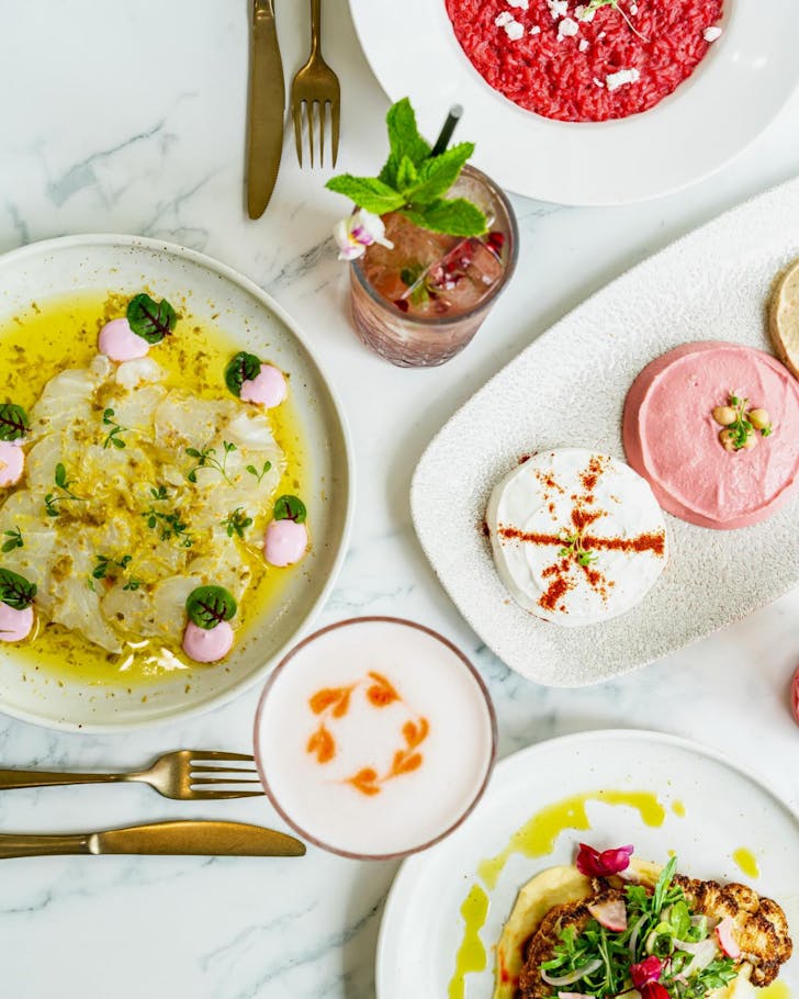 A table full of colourful dishes and cocktails at Levanti Restaurant in Townsville.